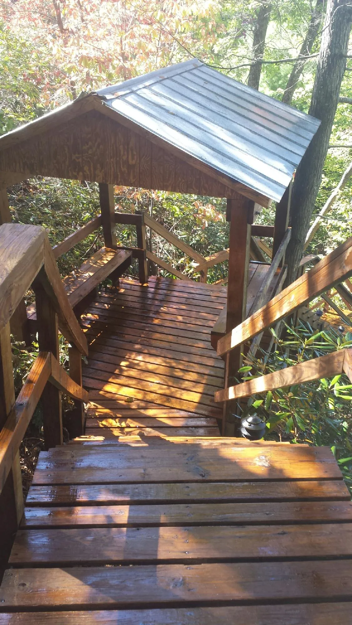 Freshly stained wood walkway and covered shelter with a metal roof in Matawan