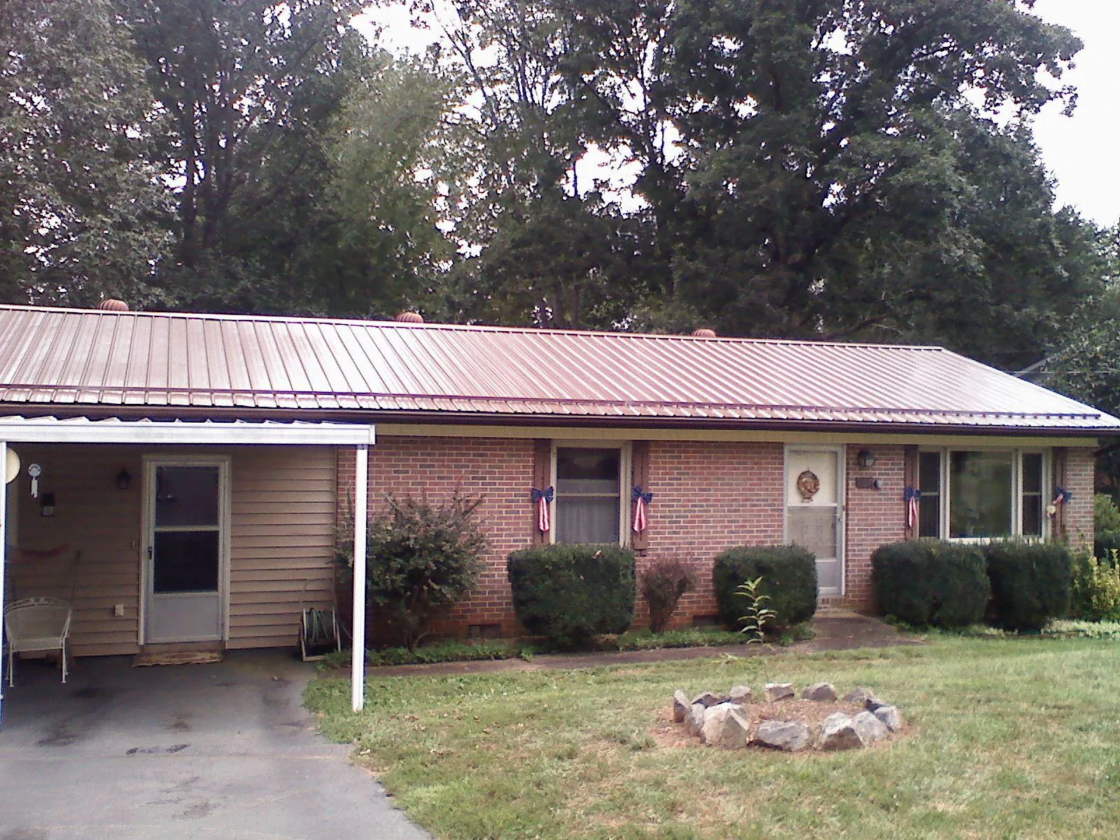 Bronze metal roof and carport on a brick ranch home — Roof Repair work by our crew in Matawan