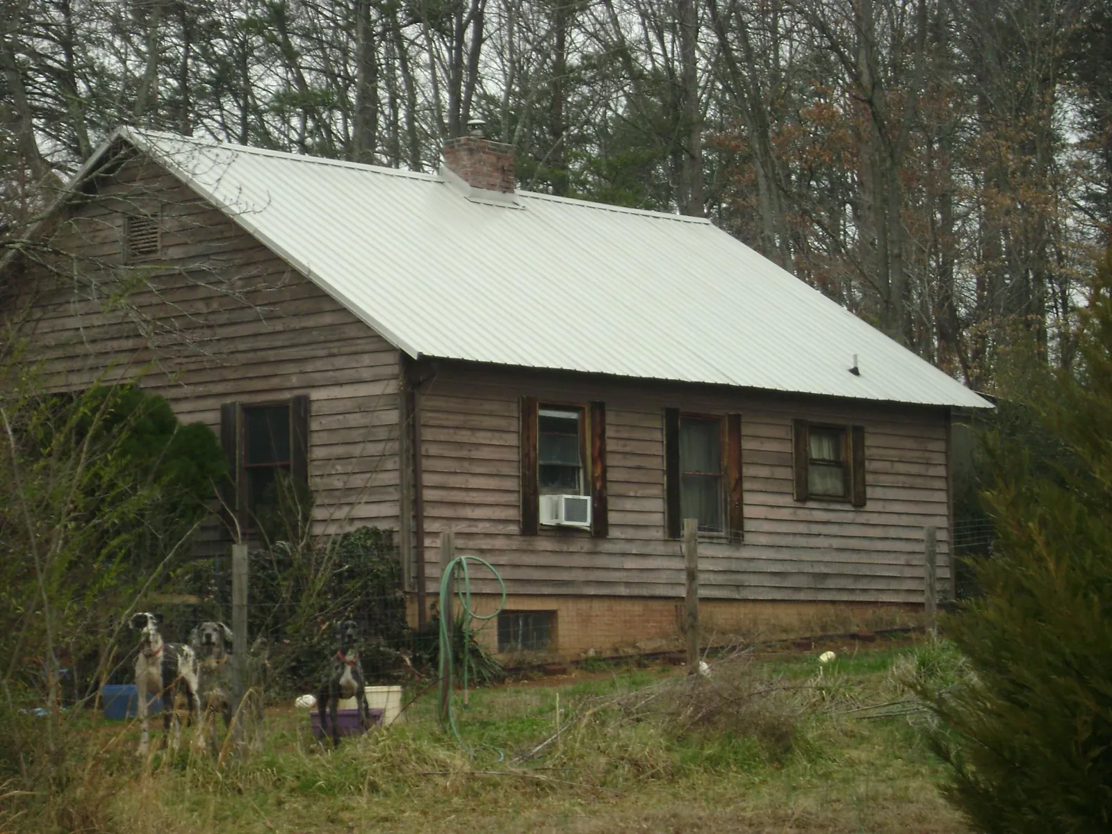 White metal roof on an old wood sided farmhouse, from a Metal Roof Installation job in Matawan